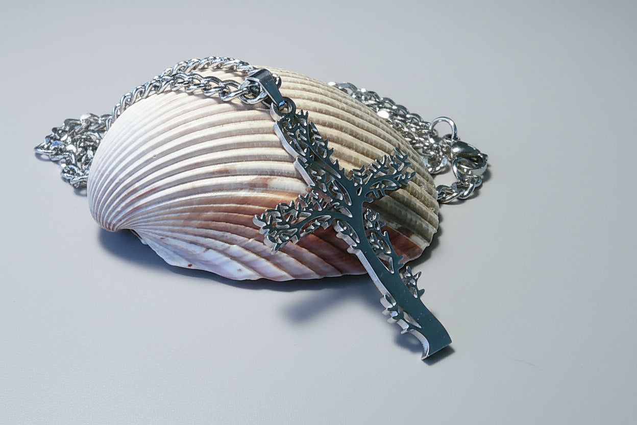Silver necklace with a tree pendant on a shell