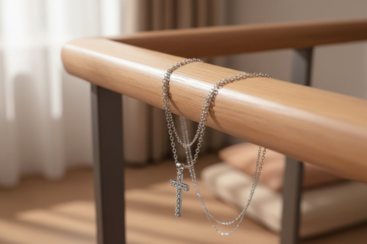 Silver cross necklace on a beige surface